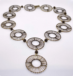 An antique gold plated brass wire-wrapped necklace with circular disc elements and a large pendant, displayed on a clean white background.