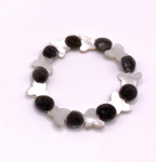 A beaded stretch bracelet featuring alternating dark gray fuzzy mgambo beads and white mother-of-pearl butterfly-shaped beads, displayed on a clean white background.