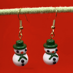 white lampwork snowmen earrings with green hat and scarf hanging from green rod