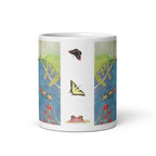 A white ceramic mug featuring a vertical wrap-around illustration of a pond scene with butterflies, flowers, and a frog, shown on a clean white background.